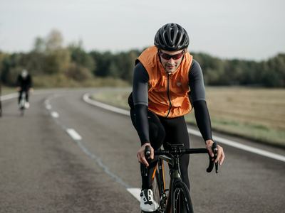 A man cycling on an open road