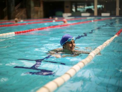 A woman swimming in a pool lane